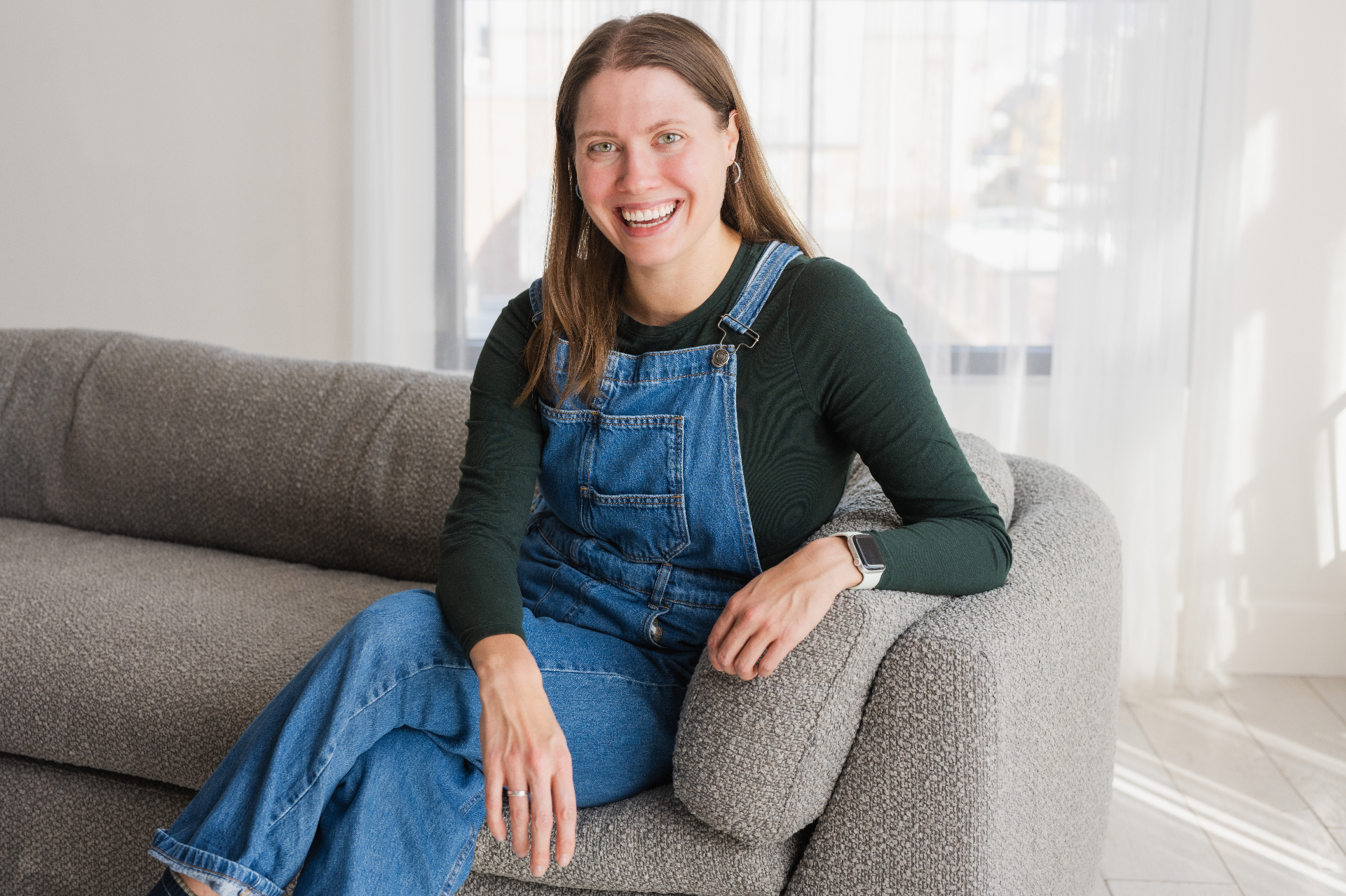 Sarah laughing on a couch